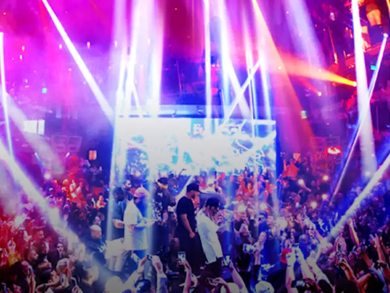 E11EVEN Miami: a nightclub crowd beneath vivid purple and pink lighting